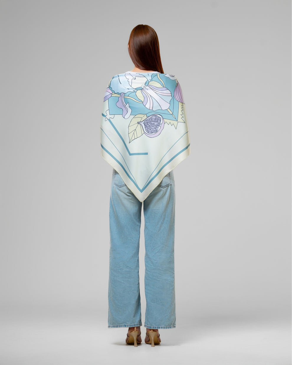 FIG SCARF IN LIGHT GREEN light green fig scarf elegantly draped over a woman&